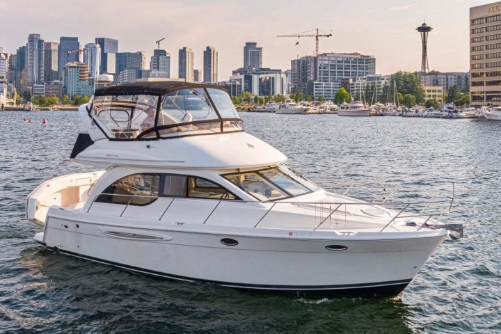 a small boat in a body of water with a city in the background